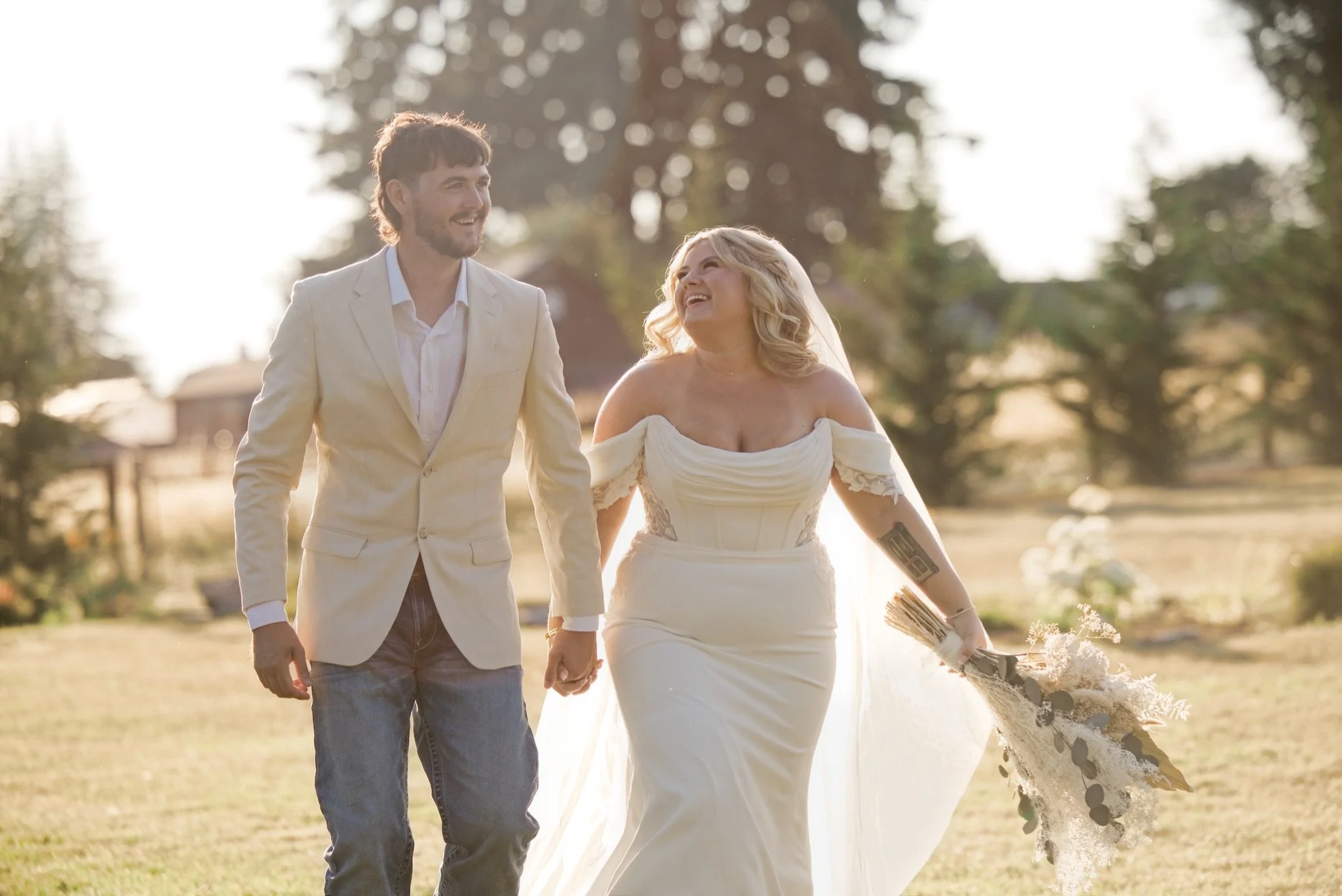 The newlyweds walking through the field in Boring Oregon