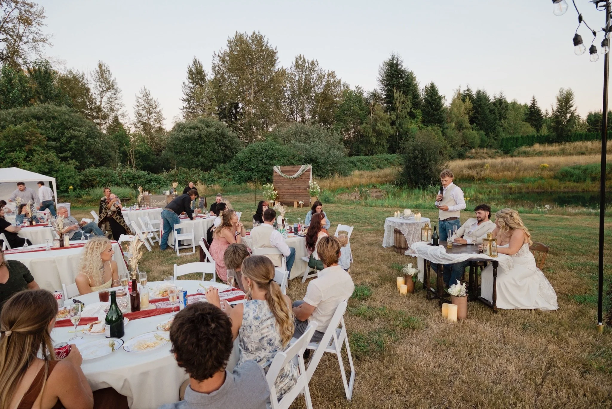 Guests at the reception tables in the backyard
