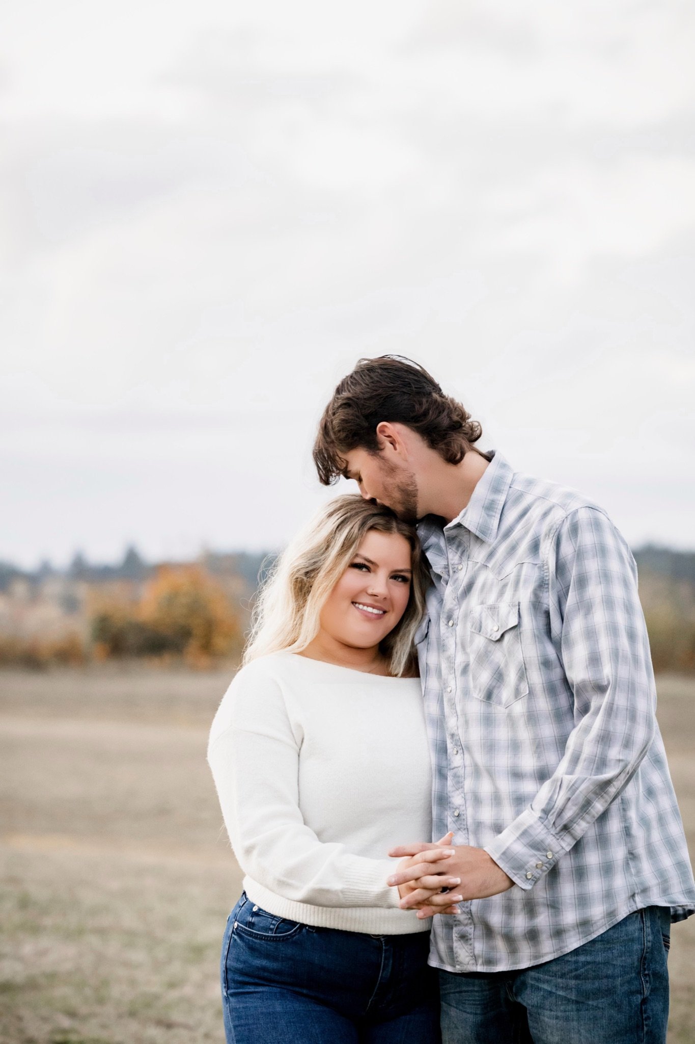 Sarah and Reed in a field during their fall engagement photos