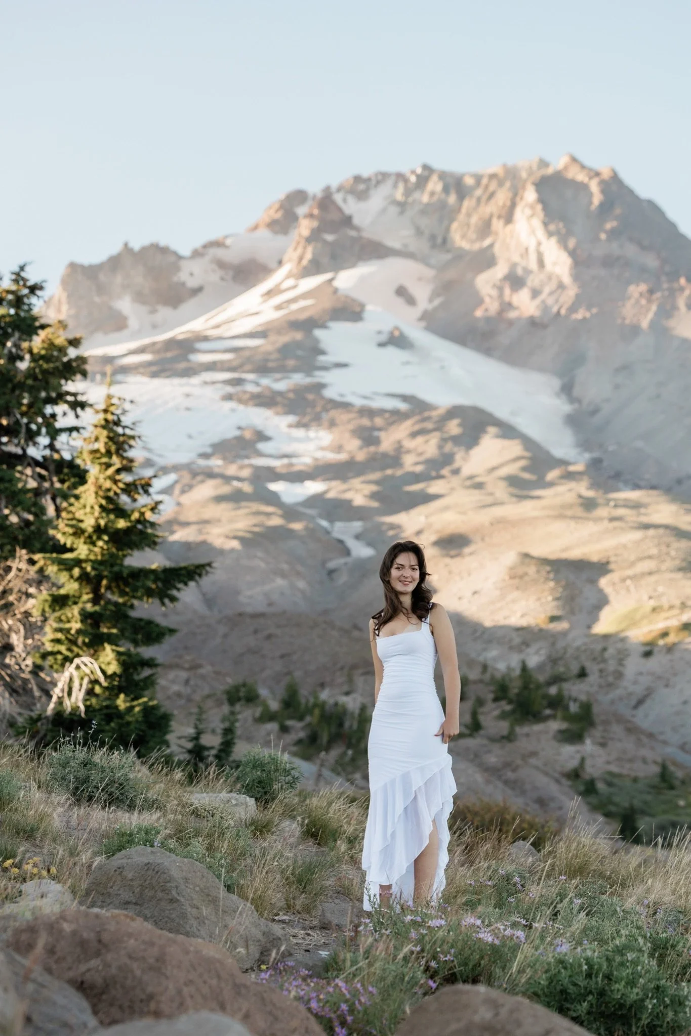 Hailey in white with the snowfields of Mt Hood lit by evening sun