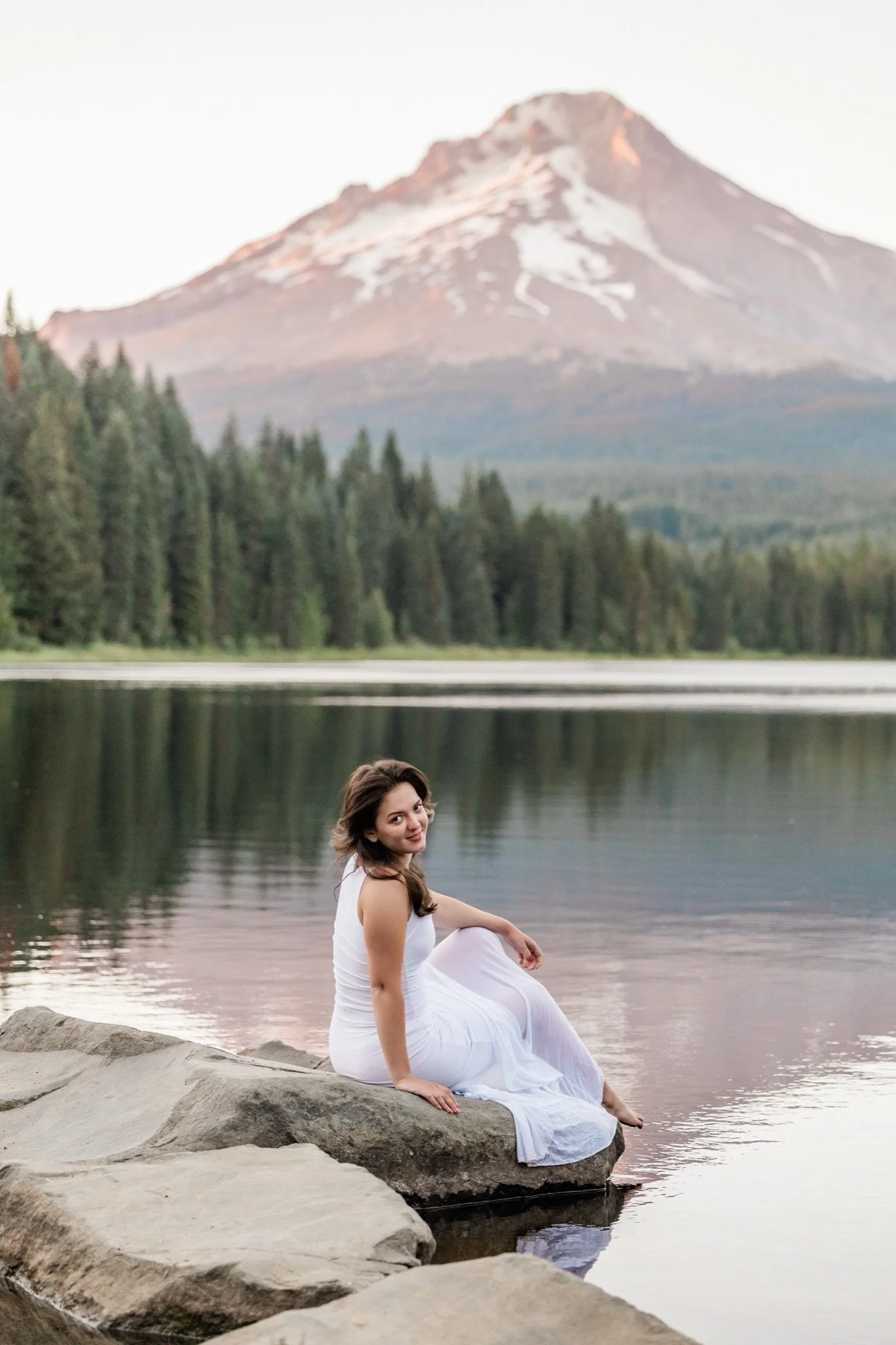 Hailey seated on the rocks at Trillium Lake at sunset, Mt Hood senior photos
