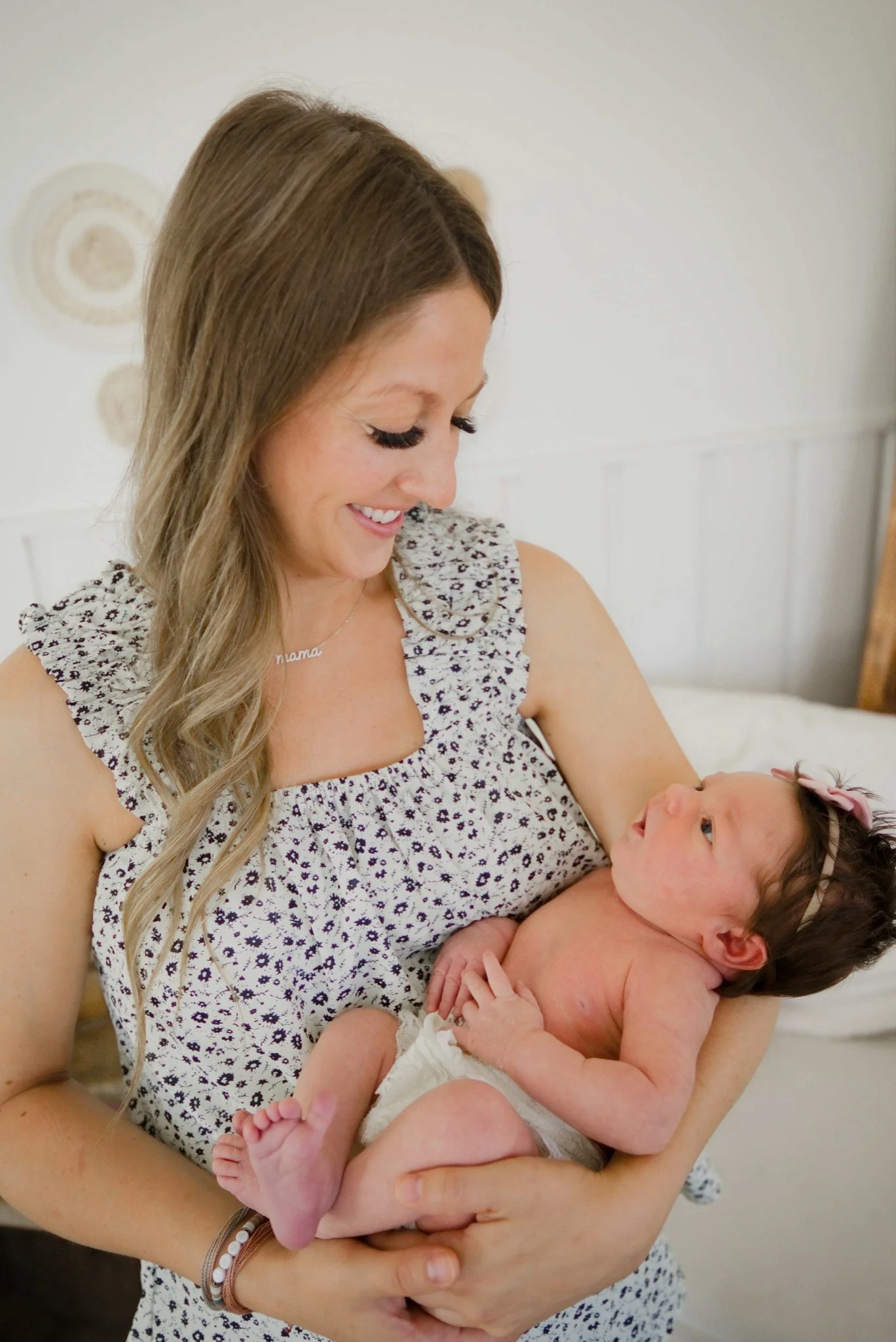 Mom smiling down at newborn Stevie in her arms