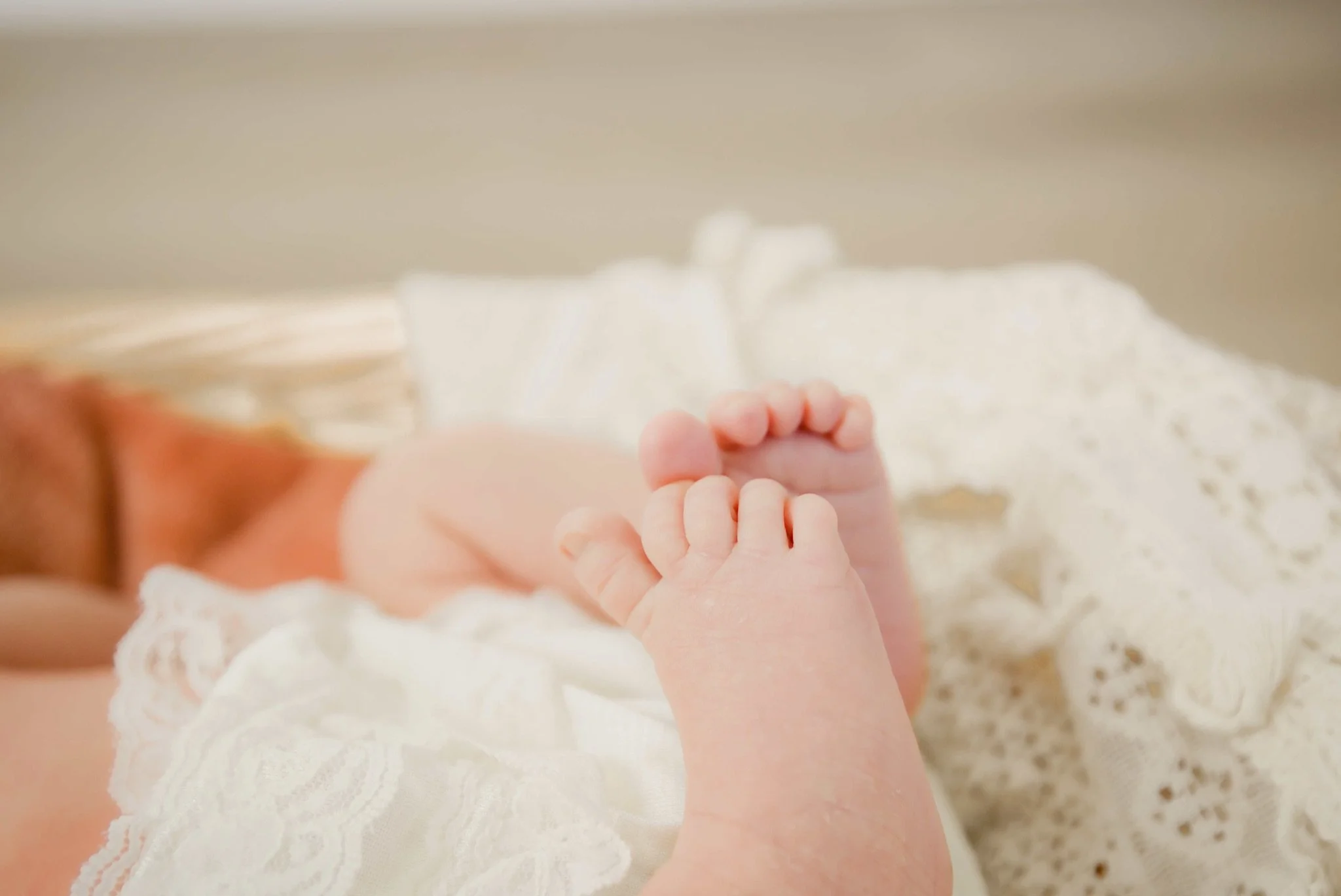 Stevie's feet peeking out from a white knit blanket