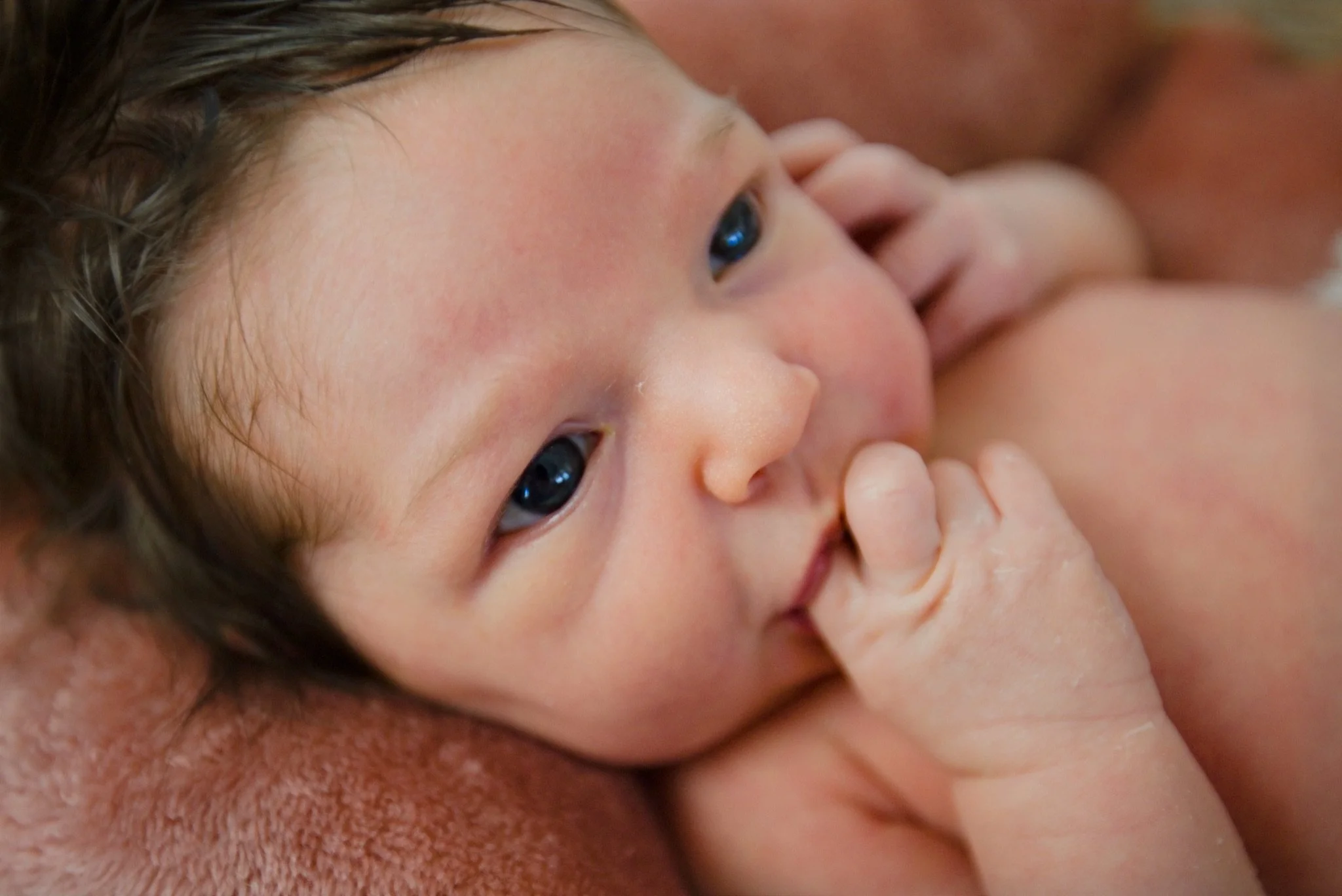 A close up of Stevie's face with her hand to her cheek