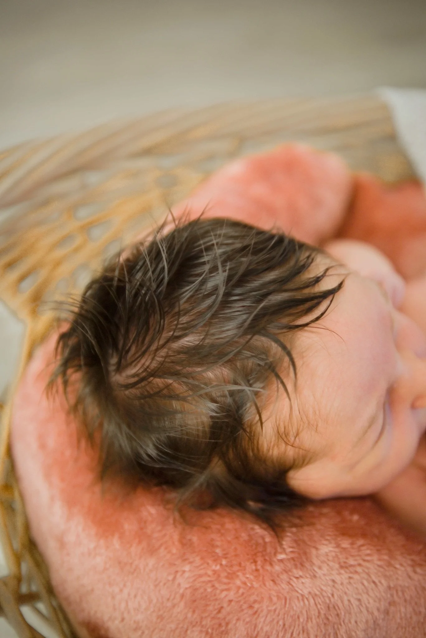 Newborn Stevie sleeping on a soft pink blanket