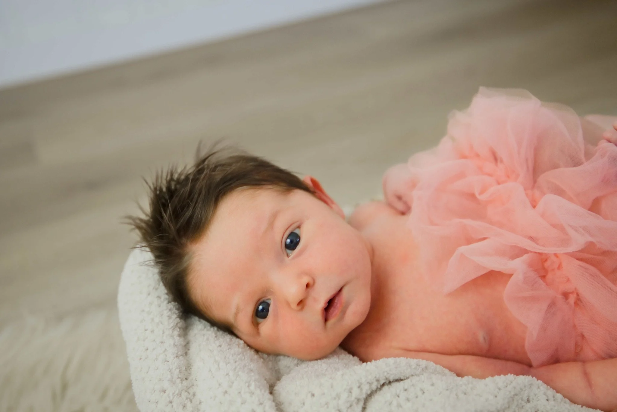 Stevie in a pink tulle wrap with her eyes open