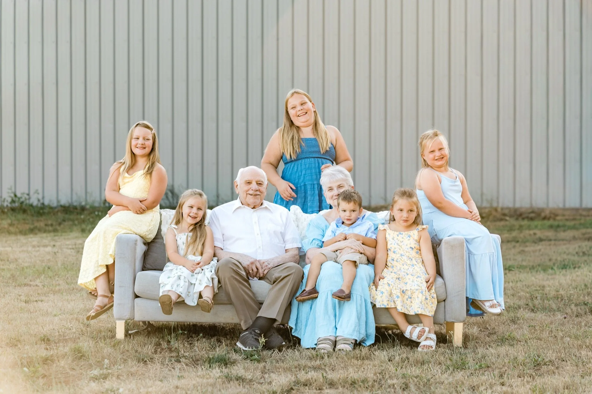 The whole family squeezed onto one couch in the field, Sandy Oregon family photographer