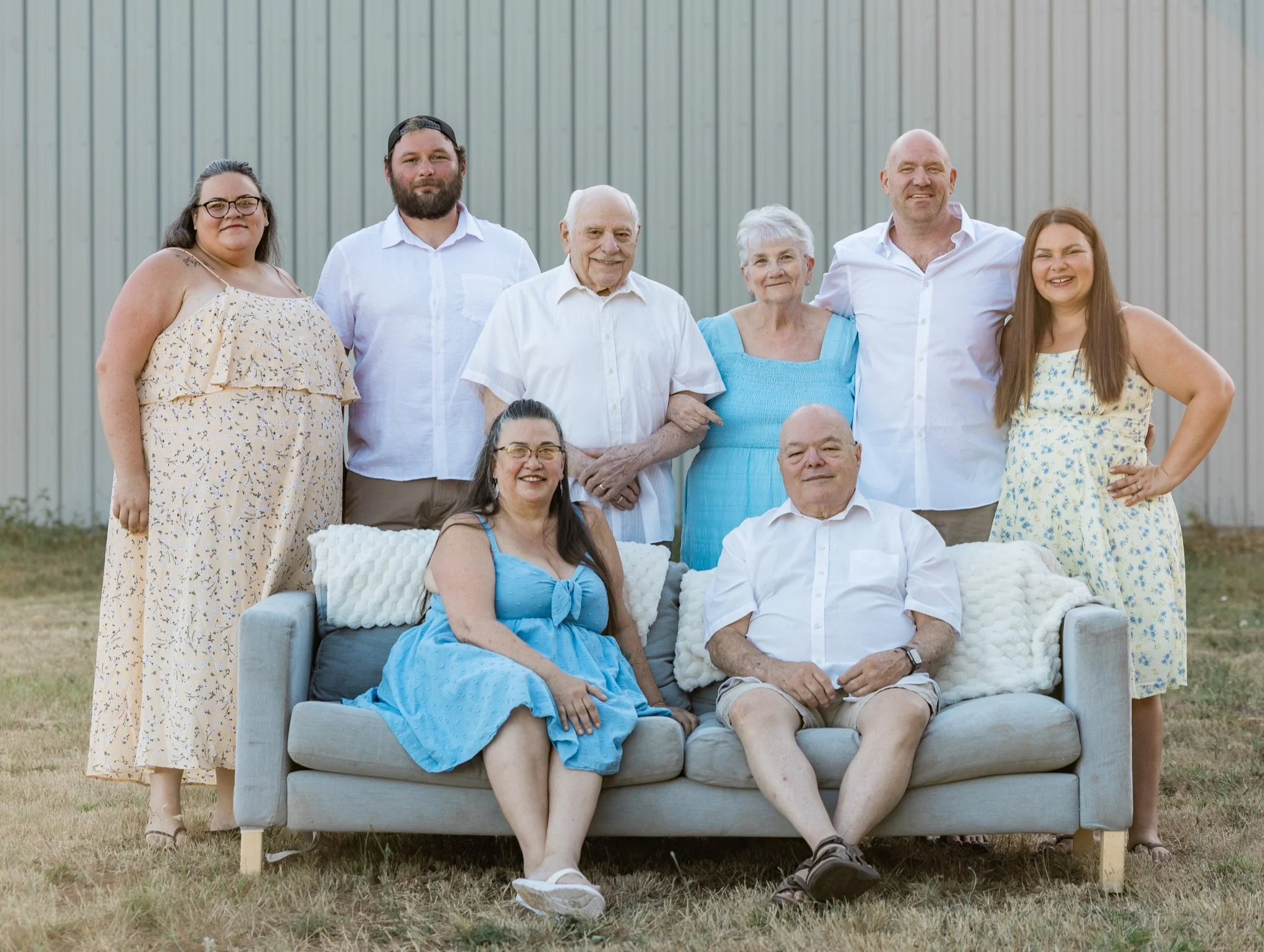 The whole family grouped around the couch in front of the barn, extended family photos near Sandy Oregon