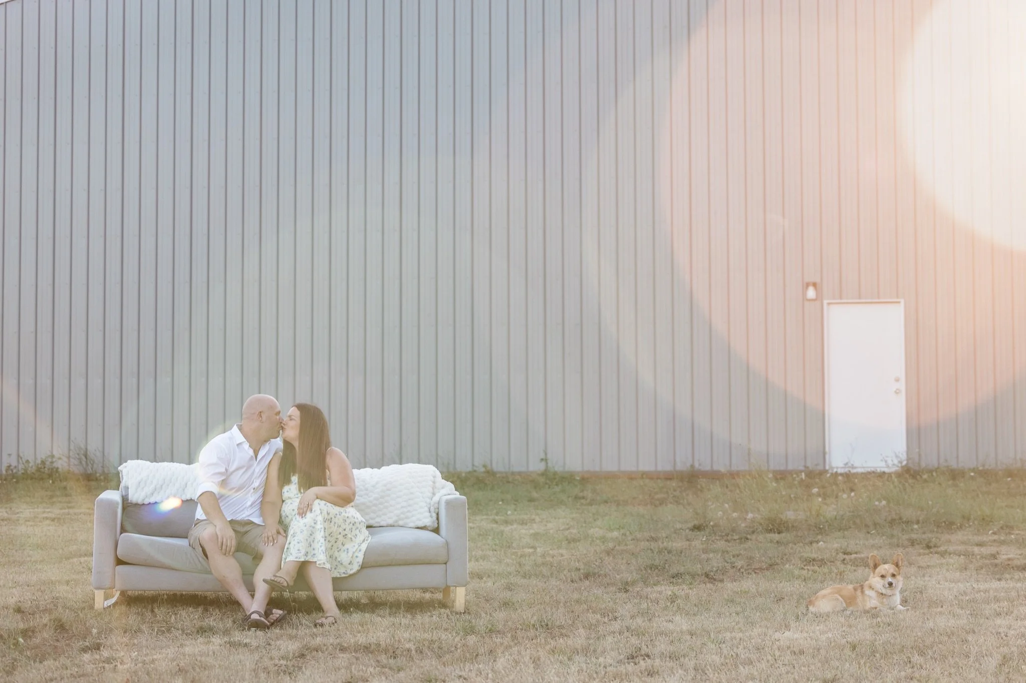 A soft backlit frame of the family on the couch in the golden haze