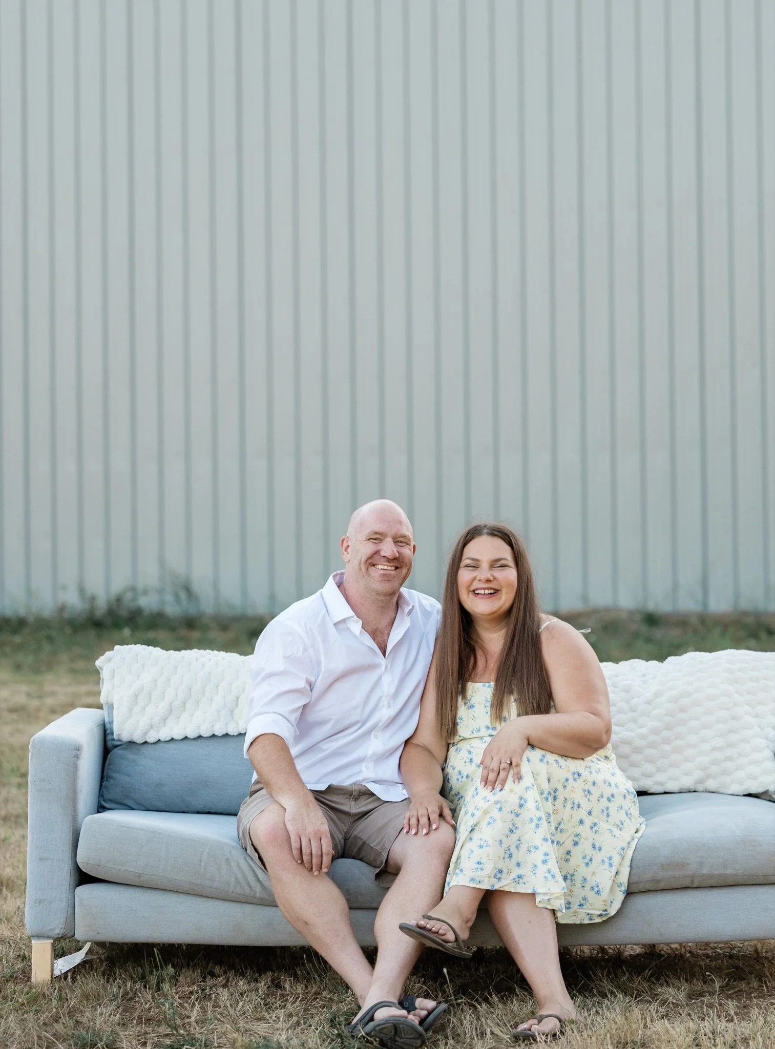 Mom, dad and their little boy on the couch in the field