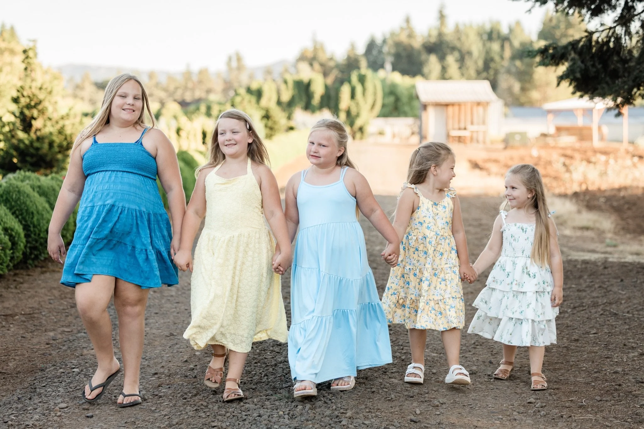 Mom and the kids walking down the lane toward the camera at golden hour