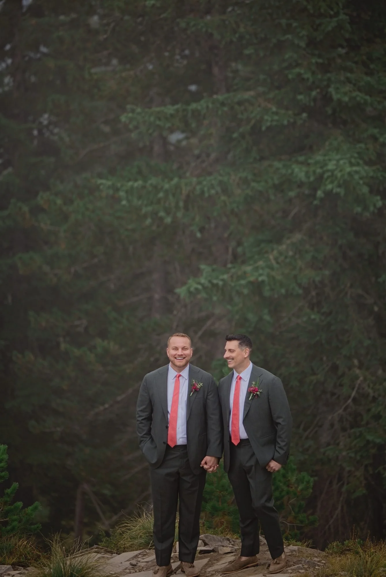 Rick and Mason standing together in the dark fir forest at Skibowl