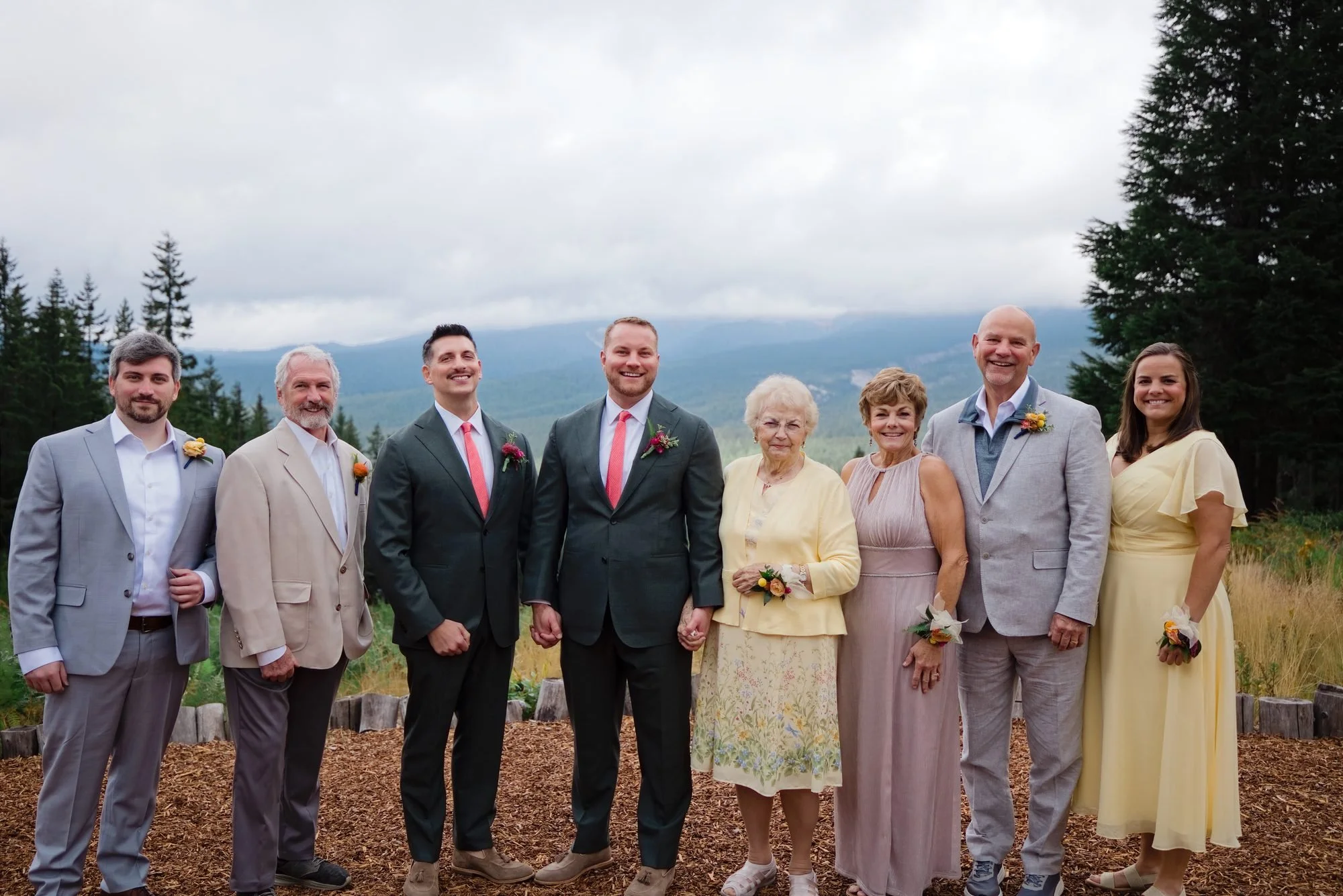 The grooms with their families in front of the mountain view at Mt. Hood Skibowl