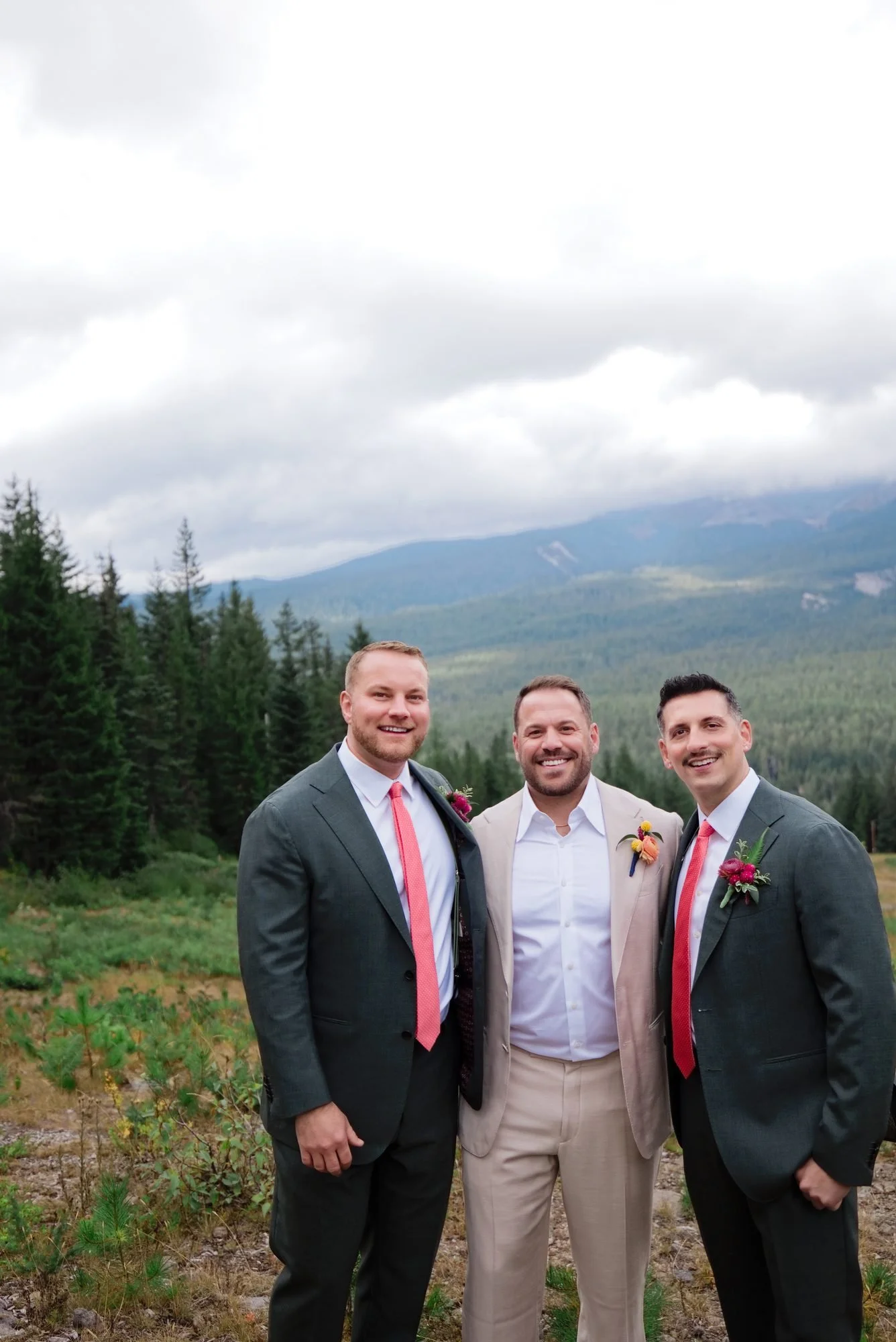 Rick and Mason laughing with a friend on the mountainside before the ceremony