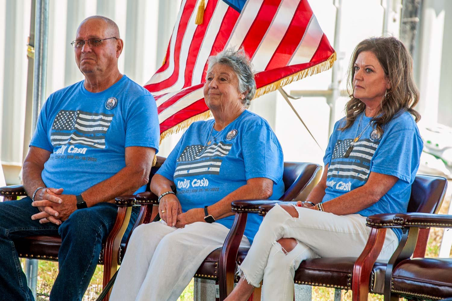  Jody Cash’s parents Harold and Teresa, and his widow Michelle, listened to the remarks of Gov. Andy Beshear during Monday morning’s ceremony. (Photo by Michael Moore) 