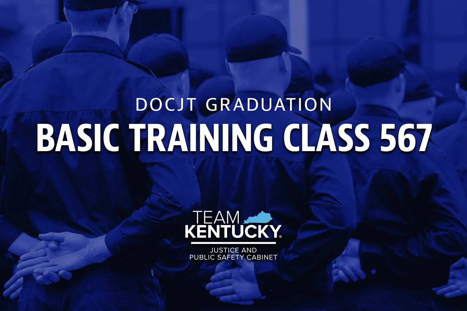 Recruits, seen from behind, standing at parade rest. Text overlay: DOCJT Graduation of Basic Training Class 567.
