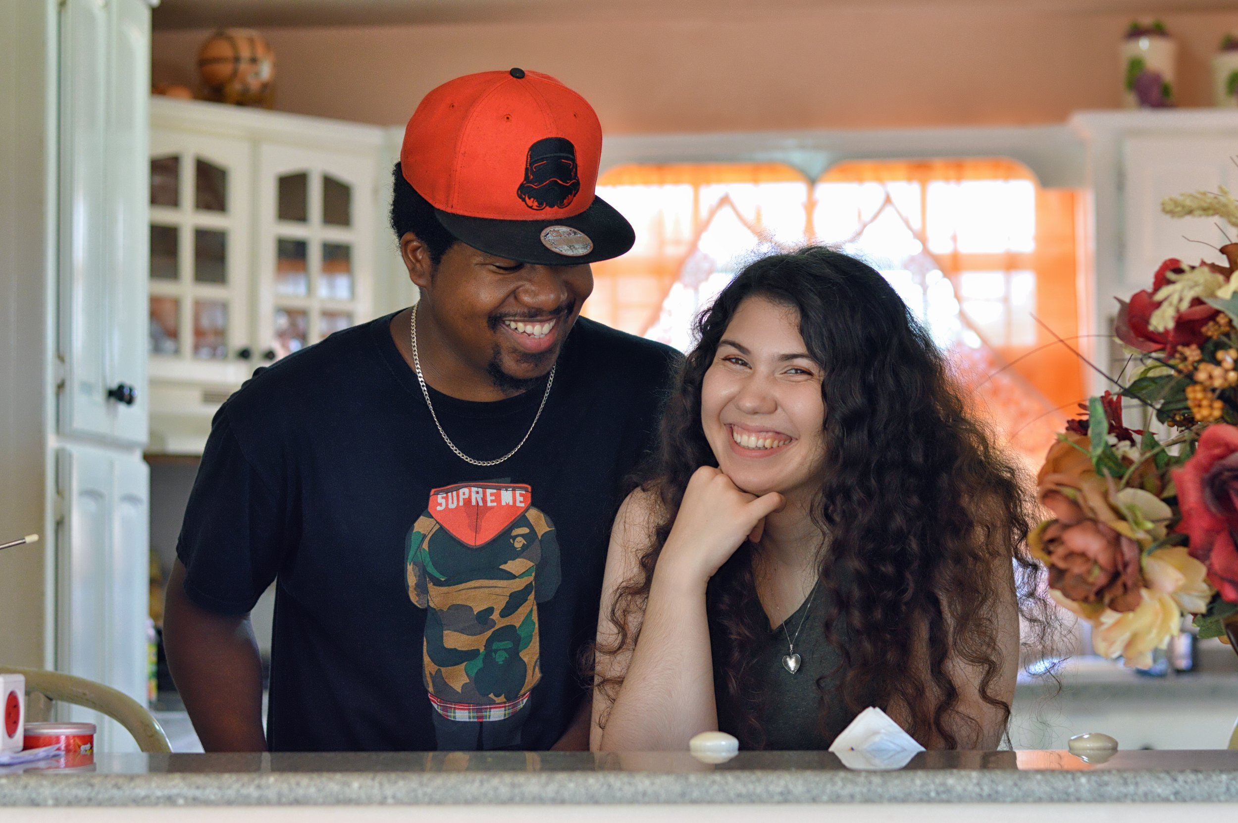 Smiling young mixed race couple in kitchen