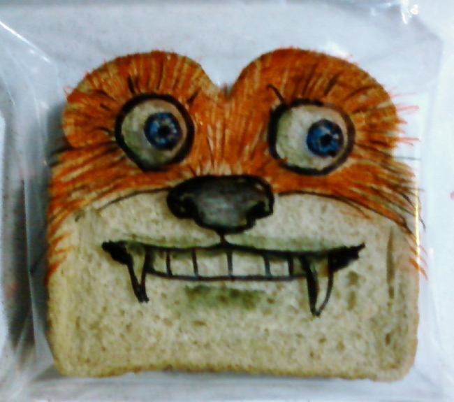 Love how the artist uses the shape of the bread to look like the top of a dog’s head