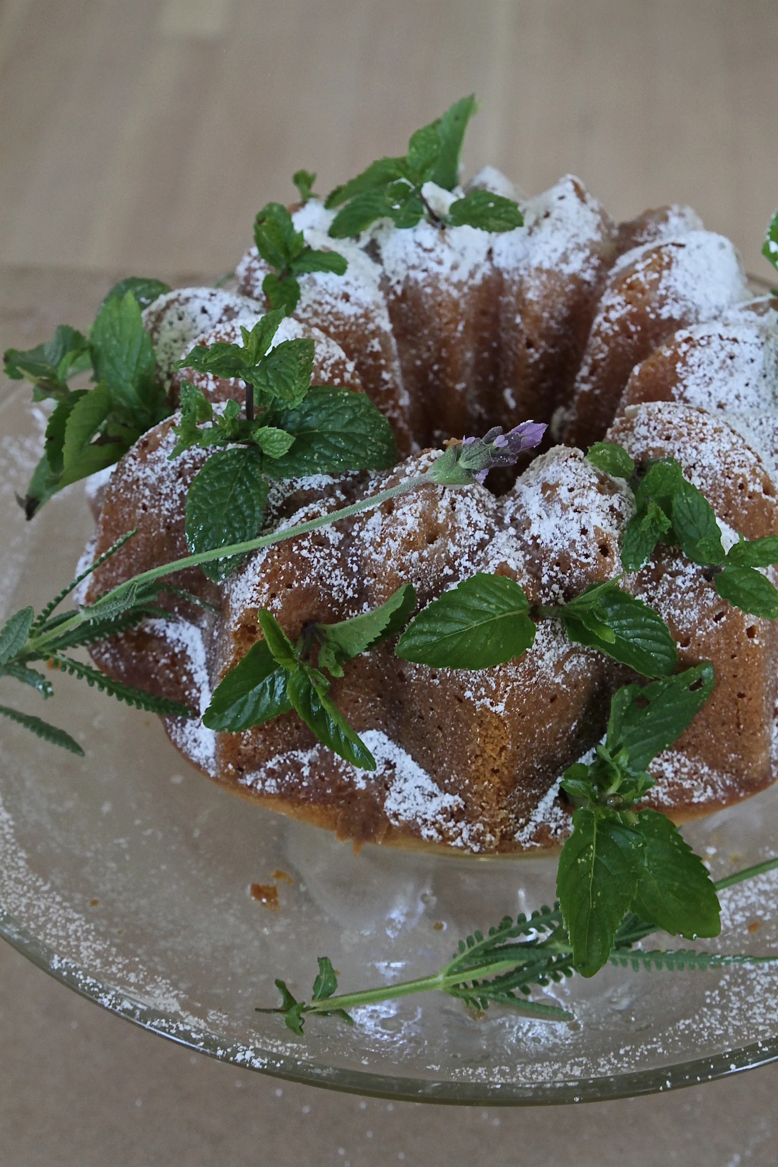 Lemon cake decorated with powdered sugar & fresh mint & lavender