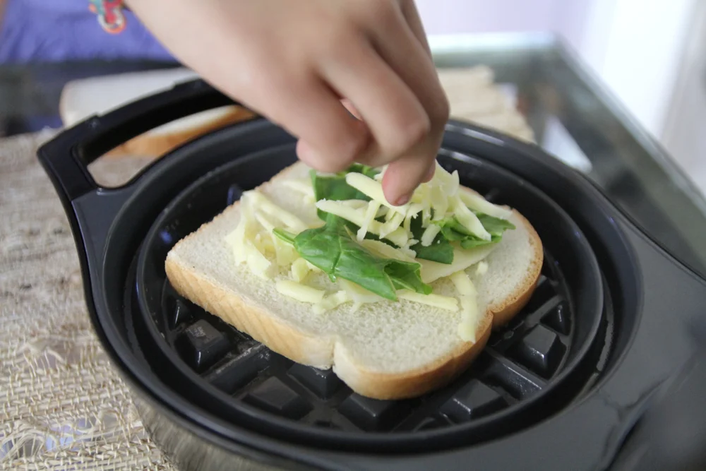 Sprinkle a thin layer of cheese & veggies on bread