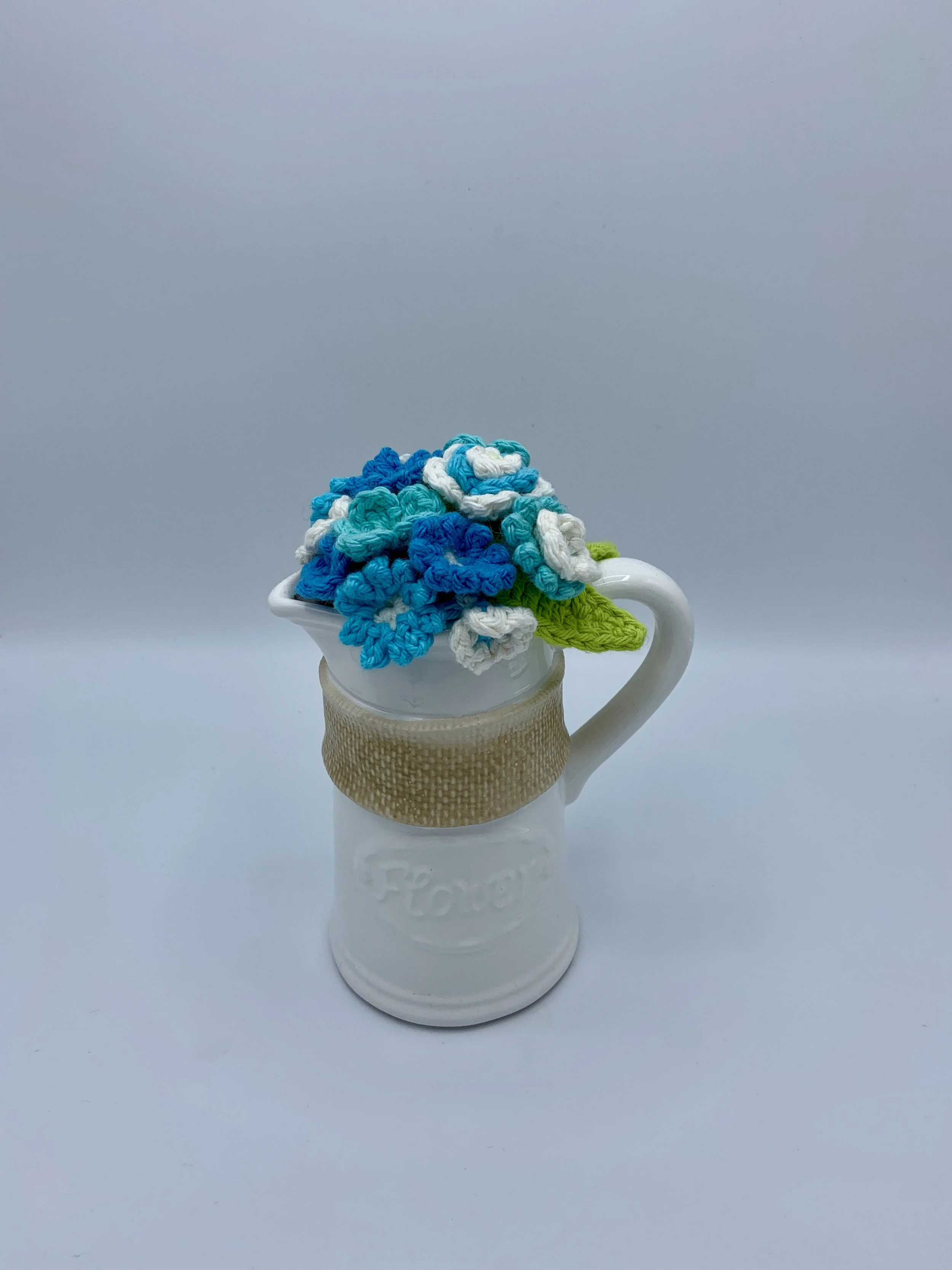 blue flower watering can