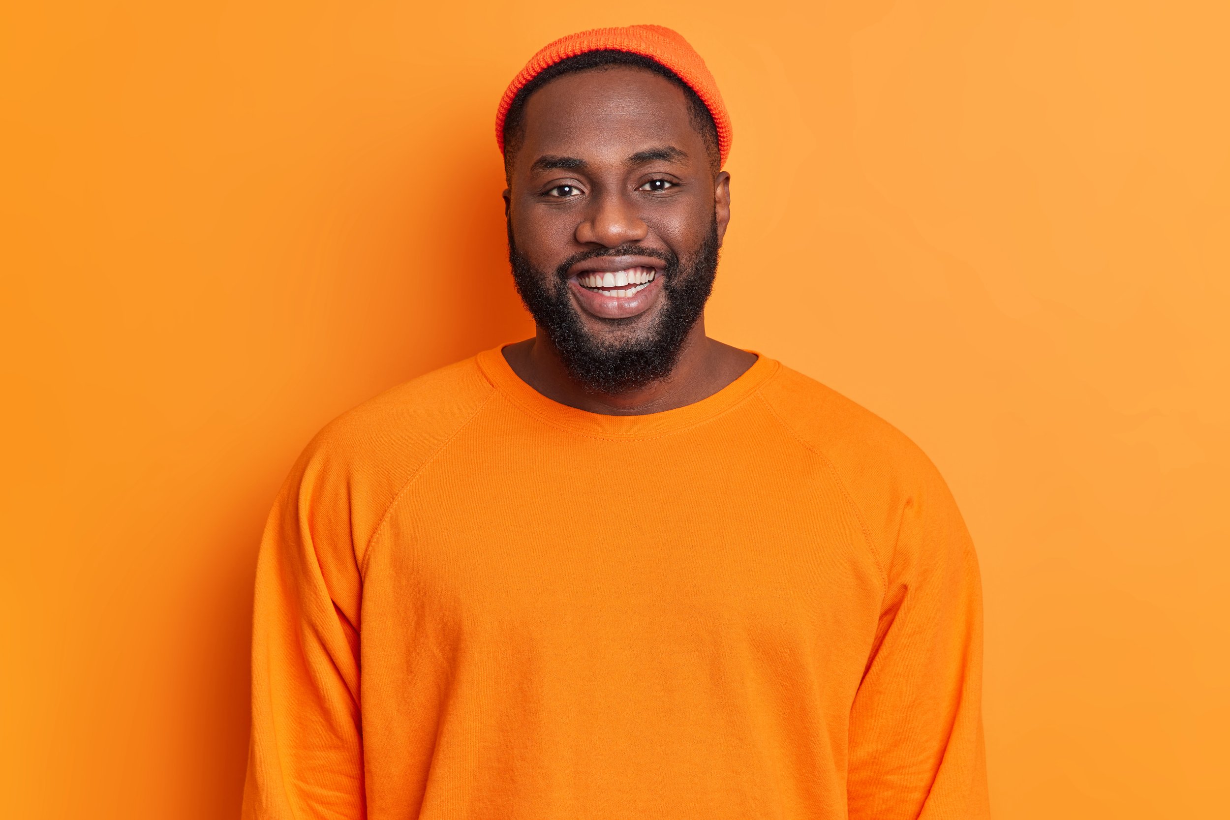 portrait-cheerful-bearded-african-american-man-has-happy-expression-smiles-broadly-has-white-perfect-teeth.jpg