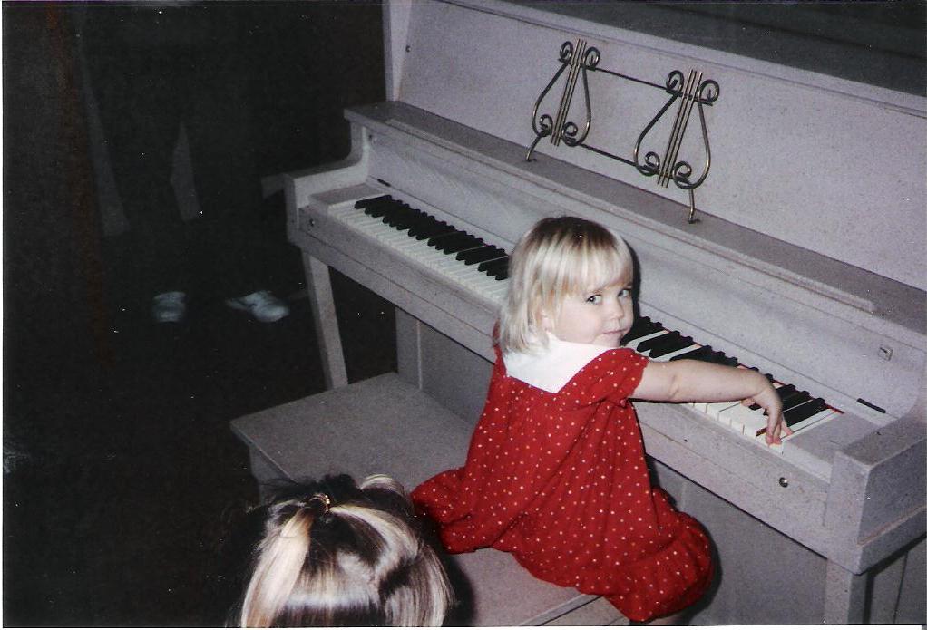 Laura at old piano.jpeg