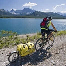 Person riding bike with a Yak Bike Trailer attached