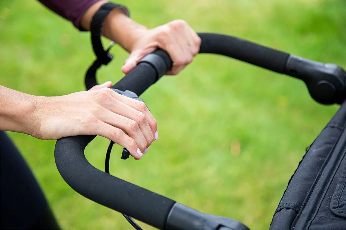 Person using wrist strap with jogging stroller