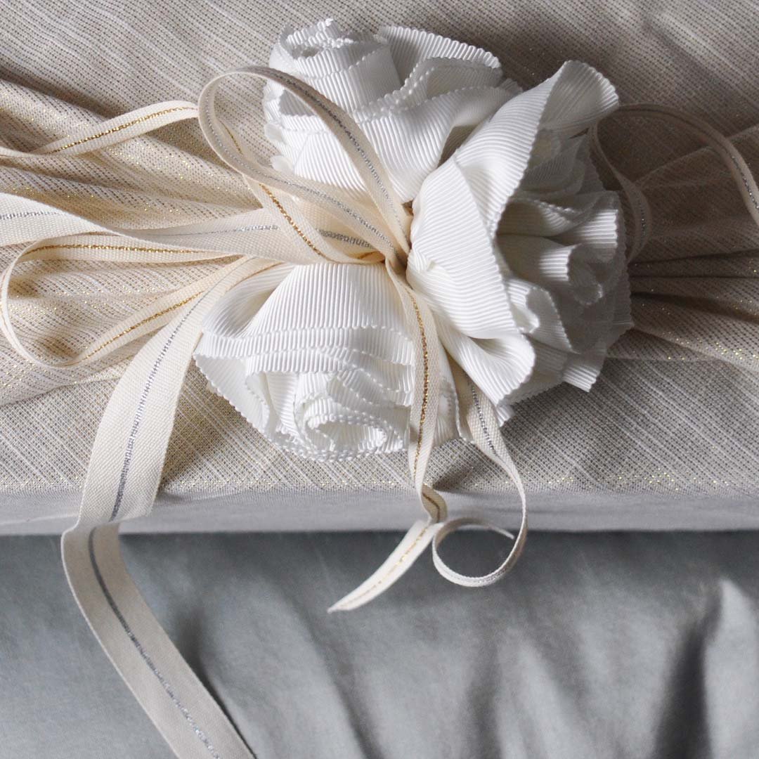Wedding gift for the bride wrapped with extra ribbon accents.