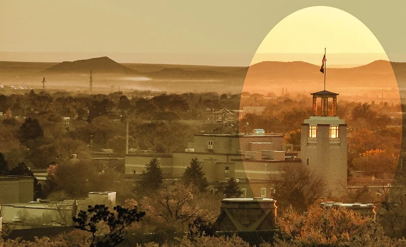 Photograph of downtown Santa Fe by Jim Hawkins (2016) from Fort Marcy Park. The 105-foot tower known as the Bataan Memorial is part of the 1950 renovation of the state capitol building of New Mexico.