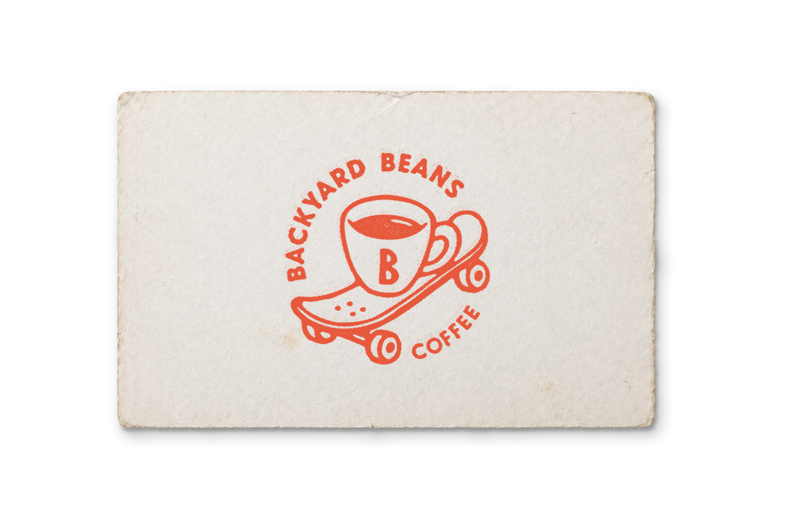 A logomark featuring a coffee mug on a skateboard for Backyard Beans Coffee.