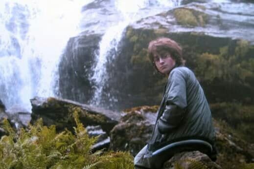 Harry sitting on rock by Waterfall.jpg