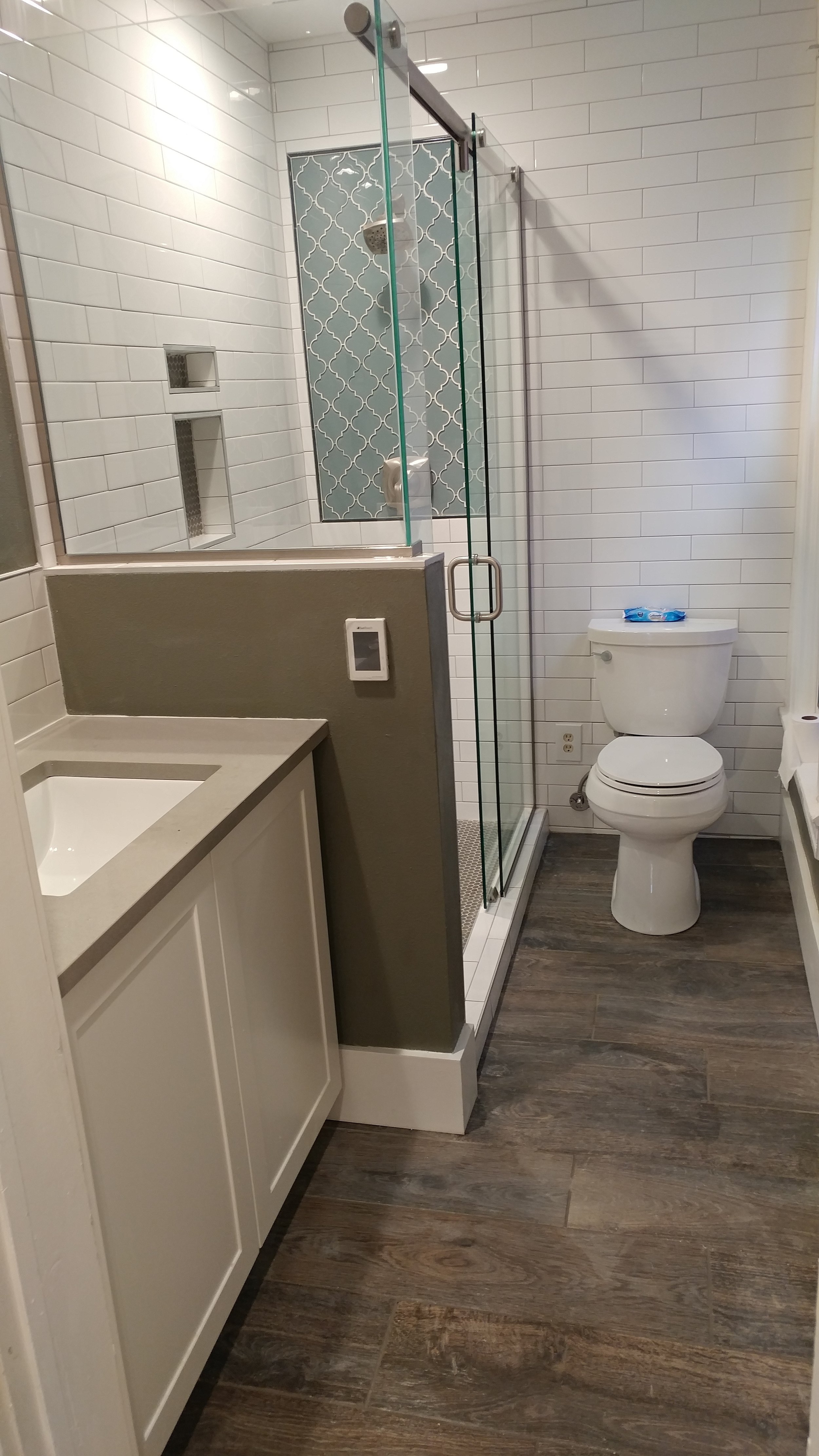 Full bathroom remodel with radiant floor heat and shower pan with glass inlay in Denver.