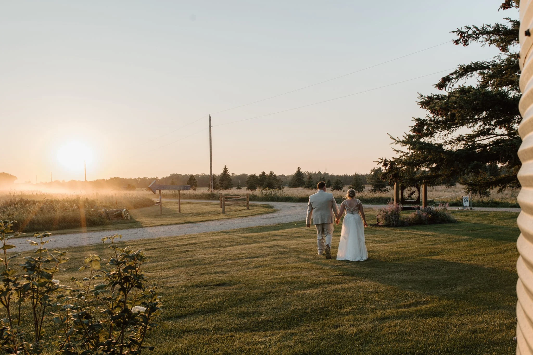 Bride & Groom walking in the sunset at Adler Ranch, MN Wedding Venue
