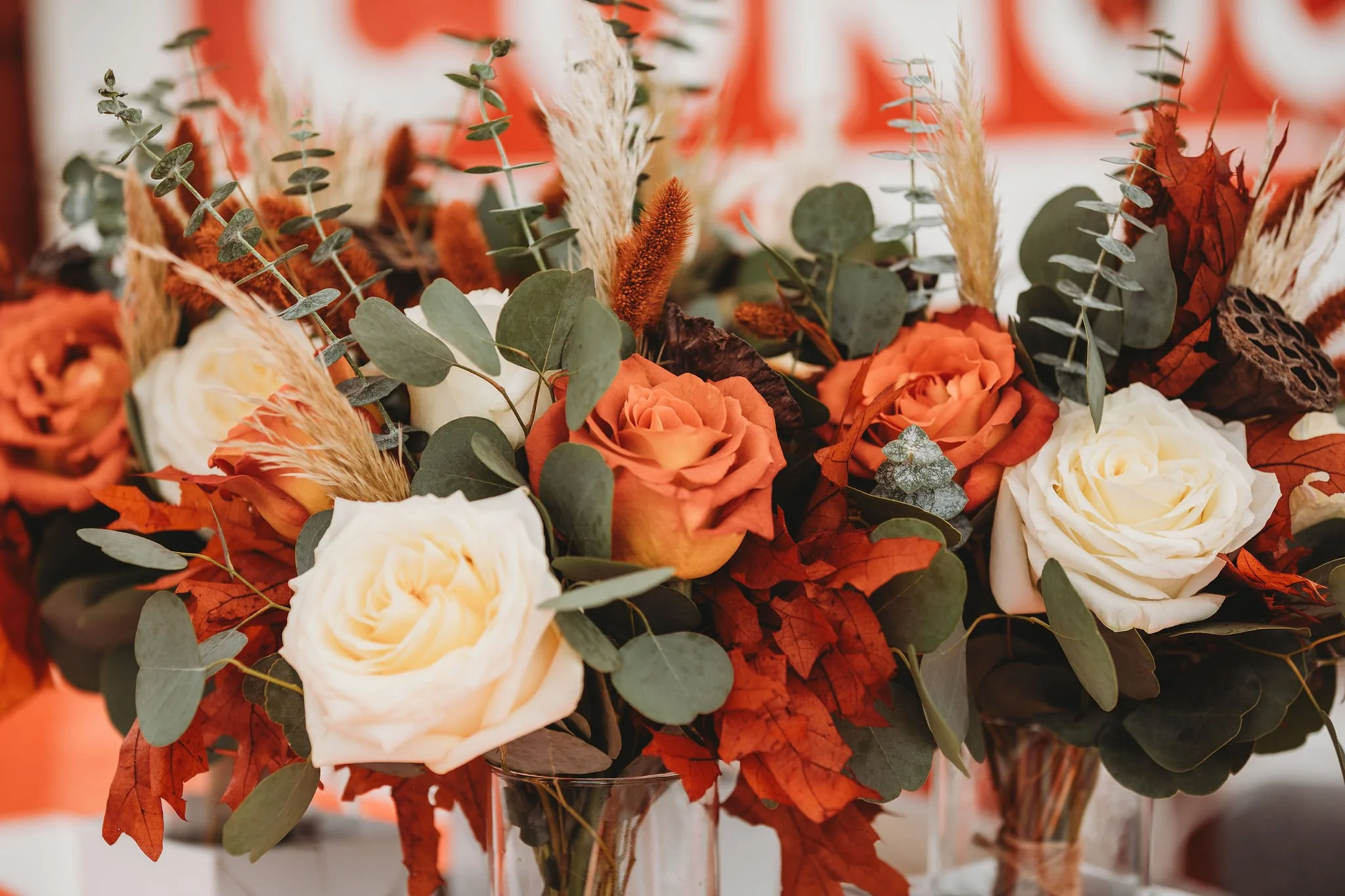 Outdoor wedding décor featuring floral arrangements and historic Conoco sign at Adler Ranch Wedding Venue in Alexandria, MN.