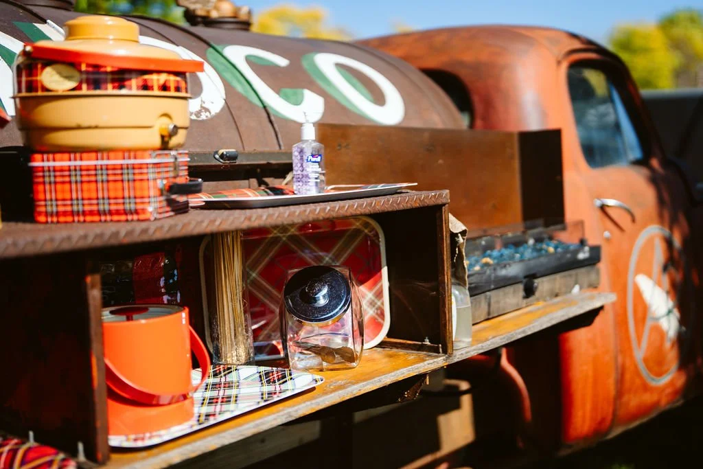 S’mores bar setup on a vintage Studebaker truck at Adler Ranch wedding venue in Alexandria Minnesota with outdoor fire feature for guests