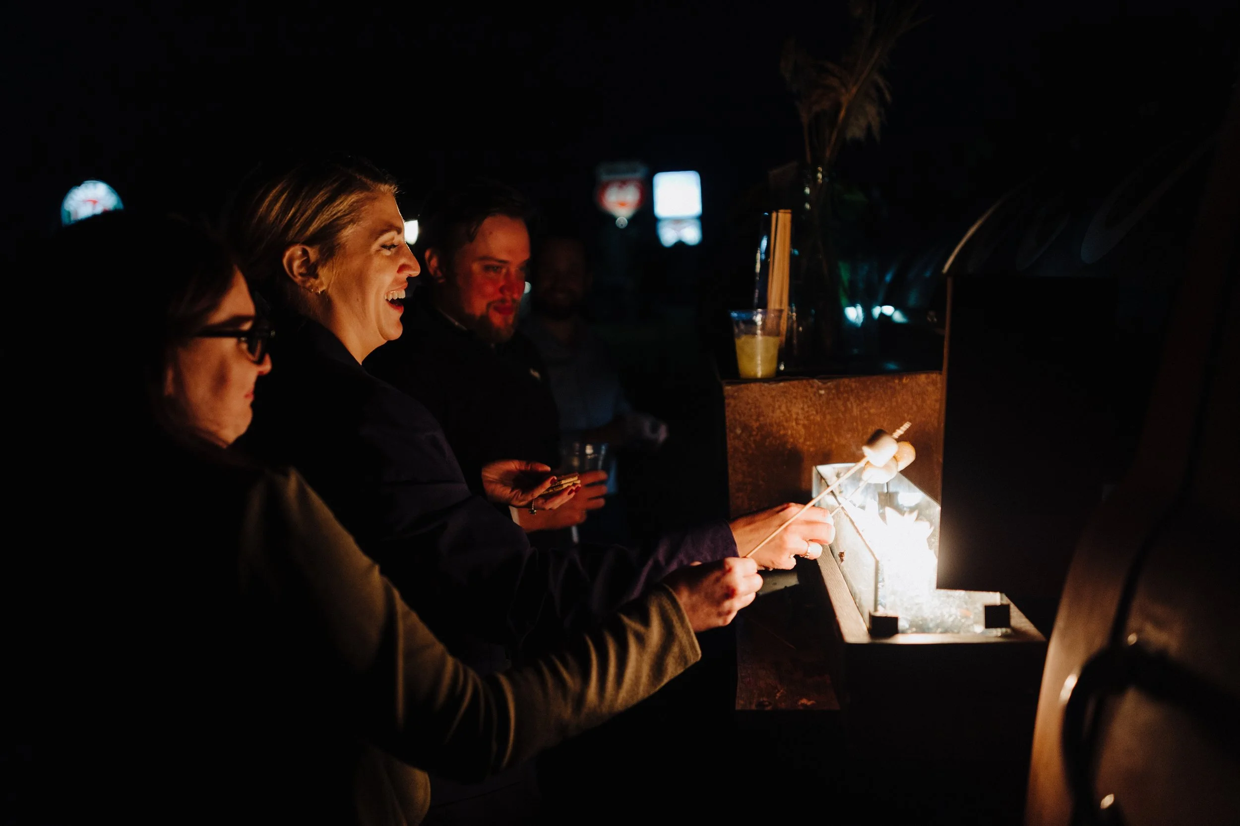 Wedding Guests cooking smores at the Adler Ranch S'more truck at Adler Ranch Wedding Venue, located near the Alexandria MN Chain of Lakes