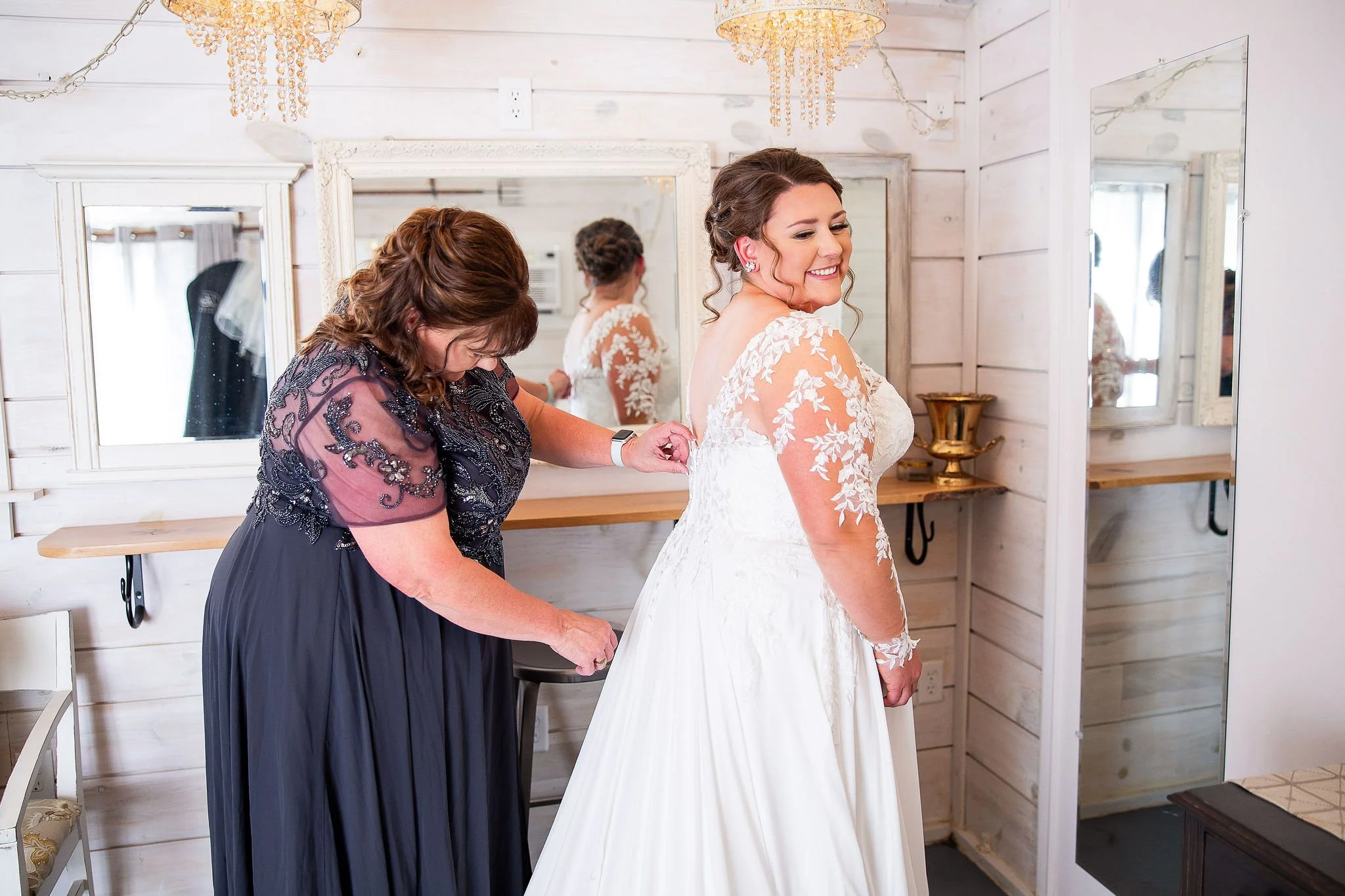 Bride and Mom getting ready in the Cabin, a wedding party suite at MN Wedding Venue Adler Ranch, what to do with leftover wedding dress material