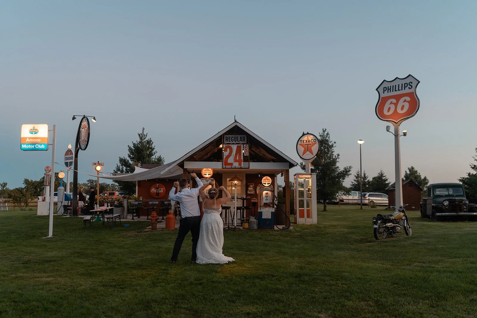 Bride & Groom dancing in front of part of the lighted sign collection at Adler Ranch Wedding Venue