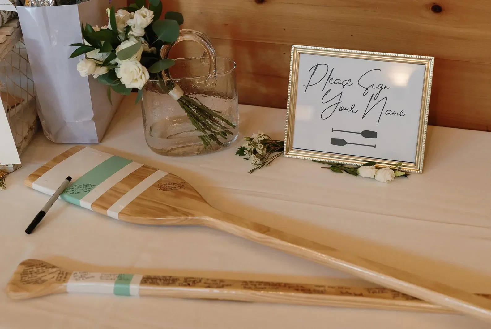 photo of paddles that can be used as an alternative wedding guestbook, Adler Ranch Wedding Venue, MN Wedding venue