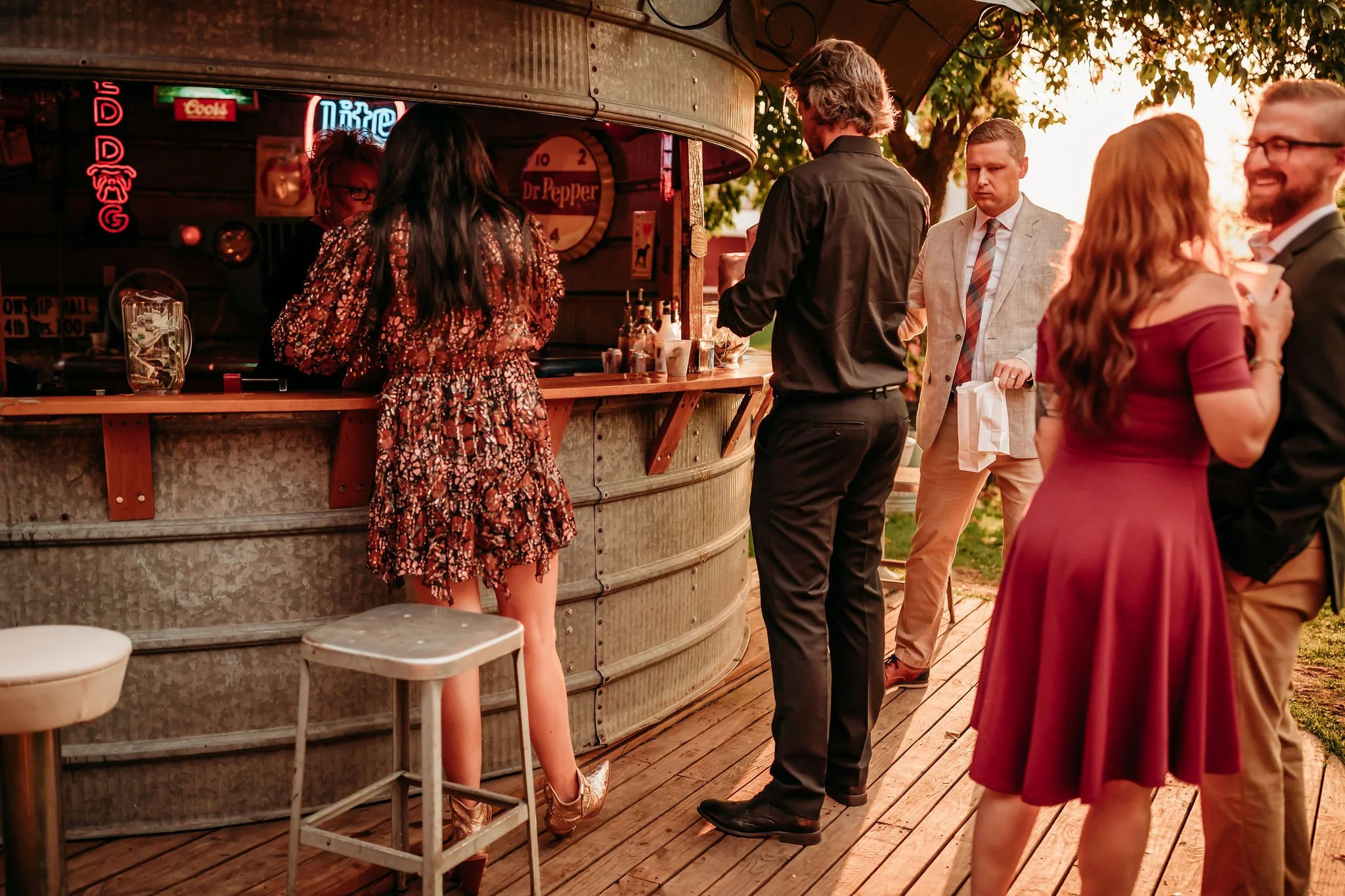 Wedding Guests enjoying the grain bin bar at Adler Ranch Wedding Venue