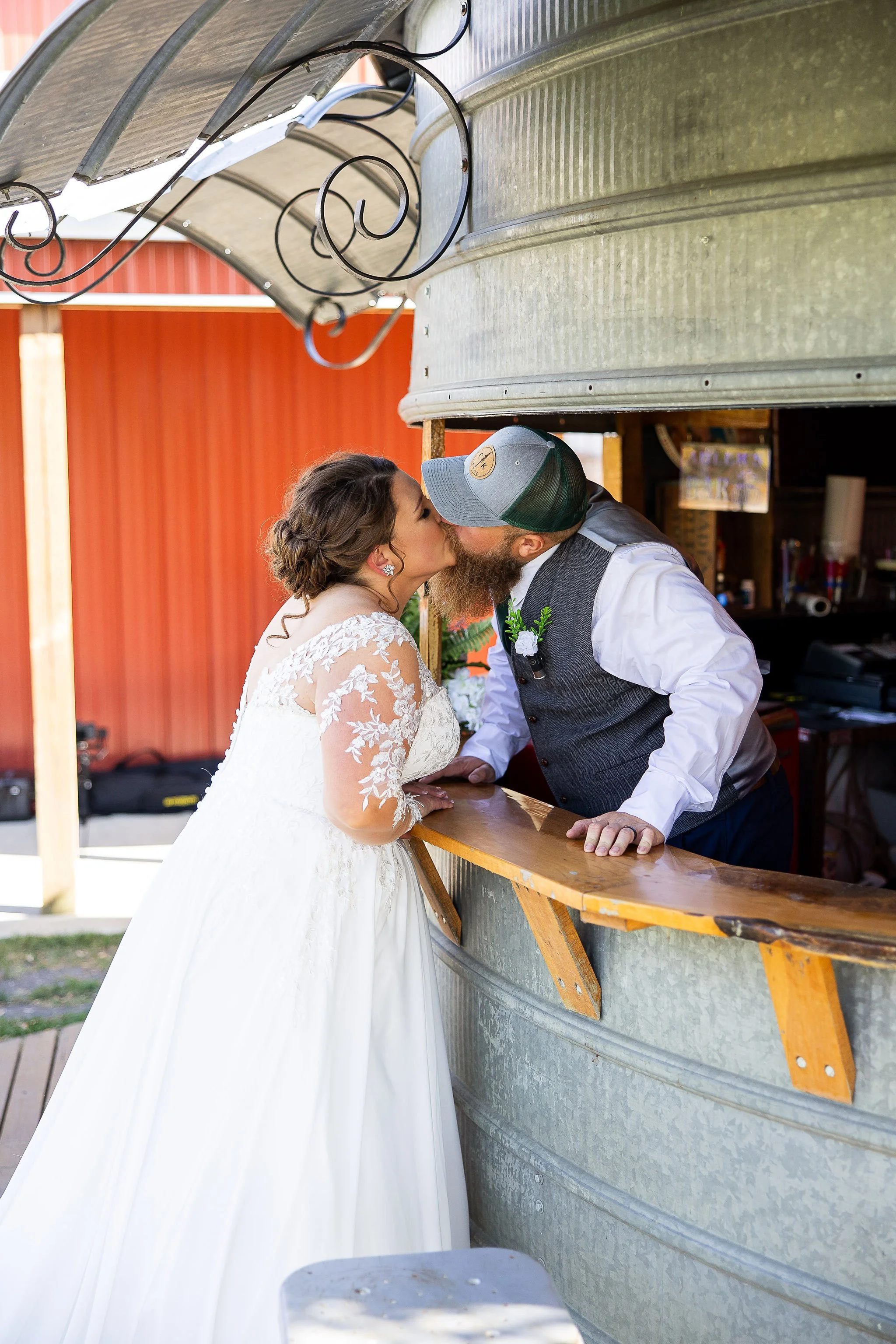 Bride & Groom share a kiss at the Grain Bin bar at Adler Ranch Wedding Venue near Alexandria MN