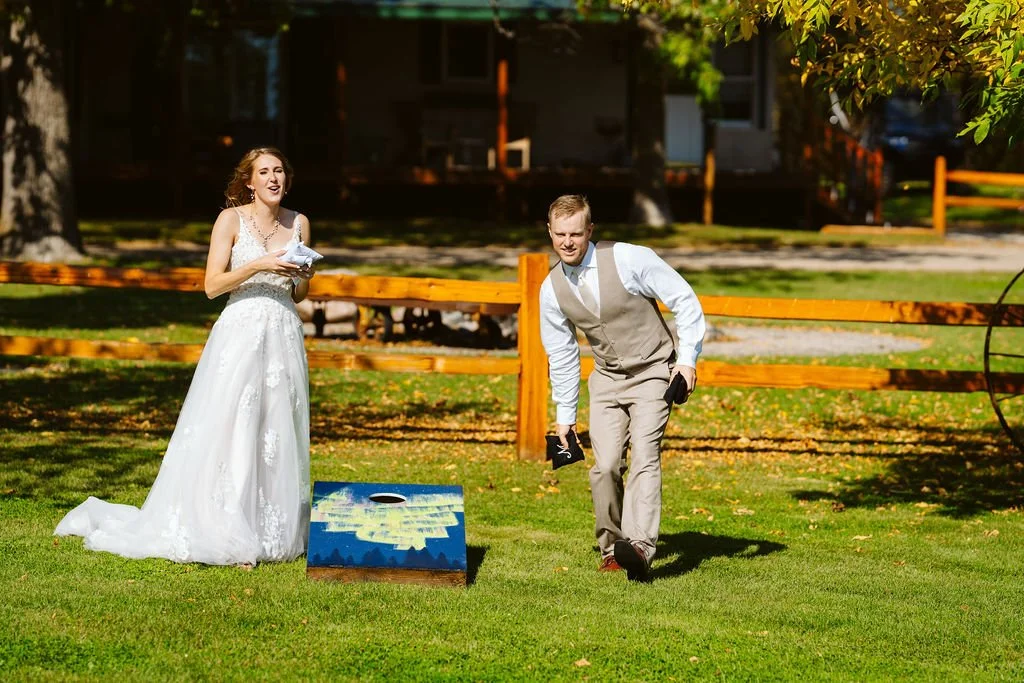 Bride & Groom play bags with their personalized bag boards on wedding day at Adler Ranch Wedding Venue, wedding near me, Alexandria MN