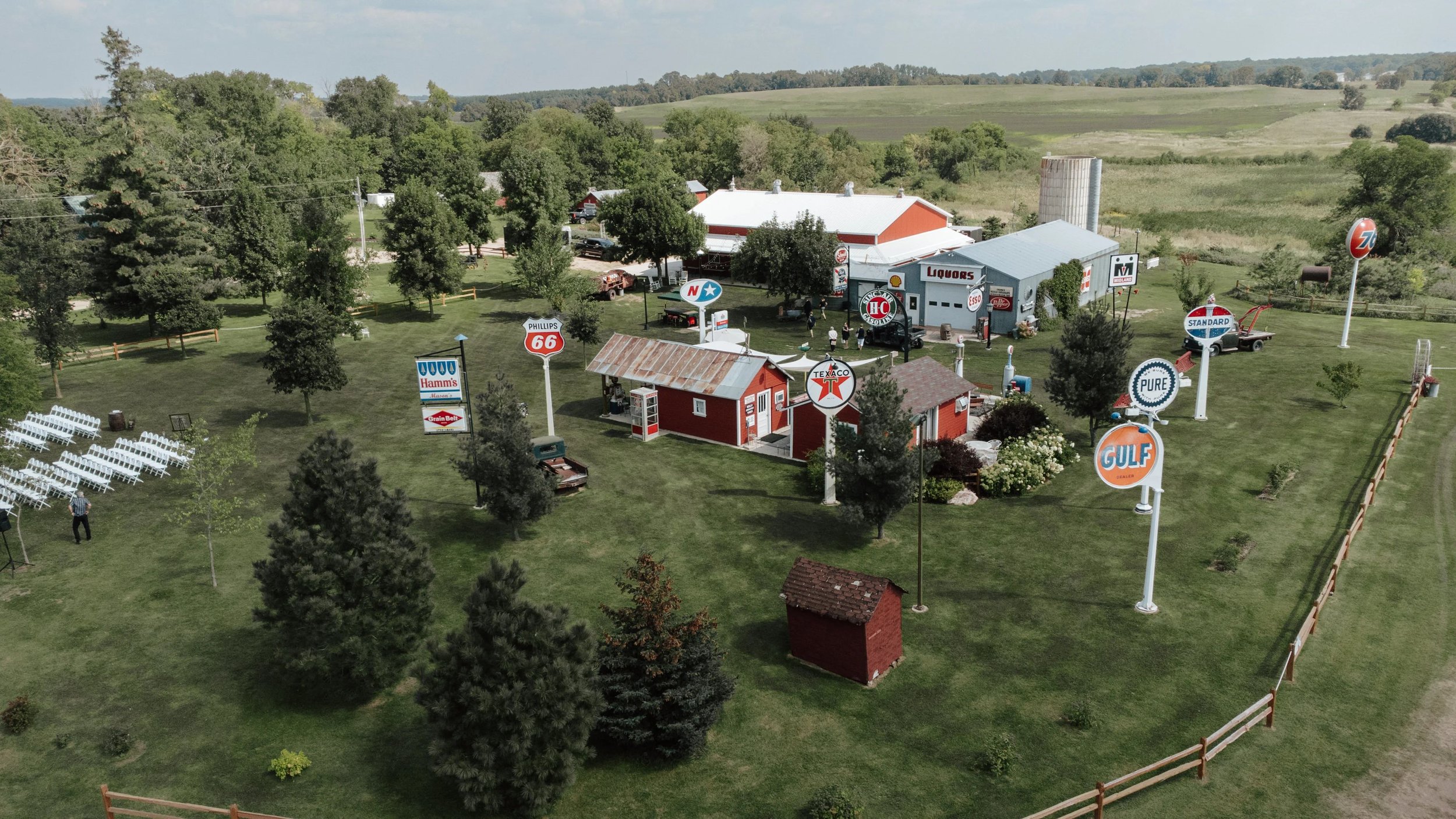 Overhead view of Adler Ranch wedding venue with vintage sign collection and wedding ceremony chairs