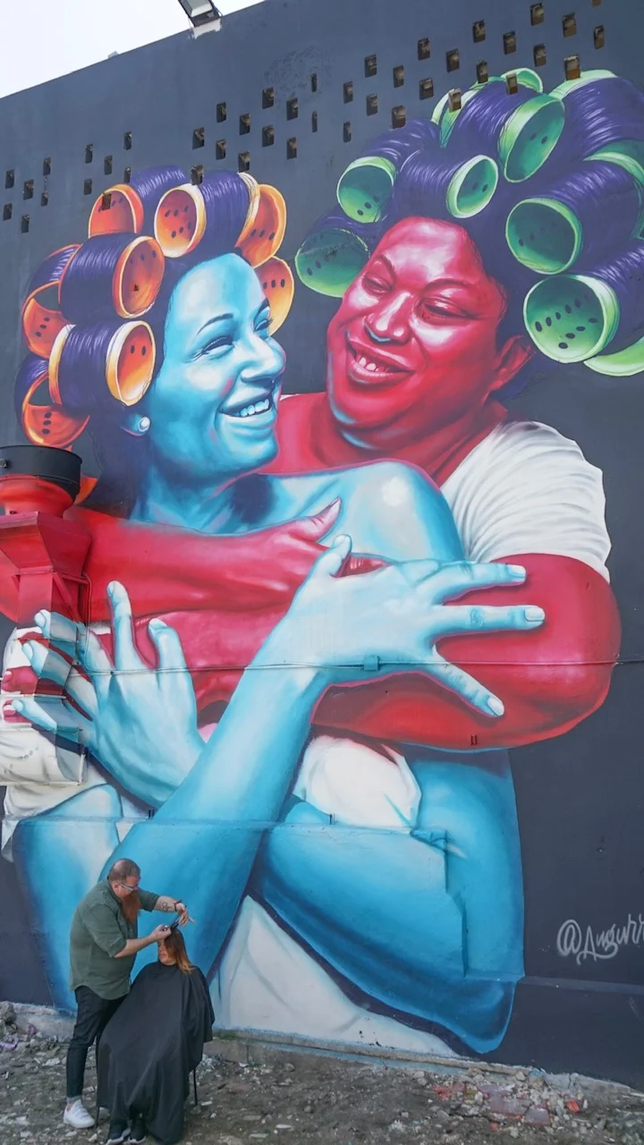DFAM Board Member Nicholas Mason cutting hair in Santurce, Puerto Rico Mural by Evaristo Angurria