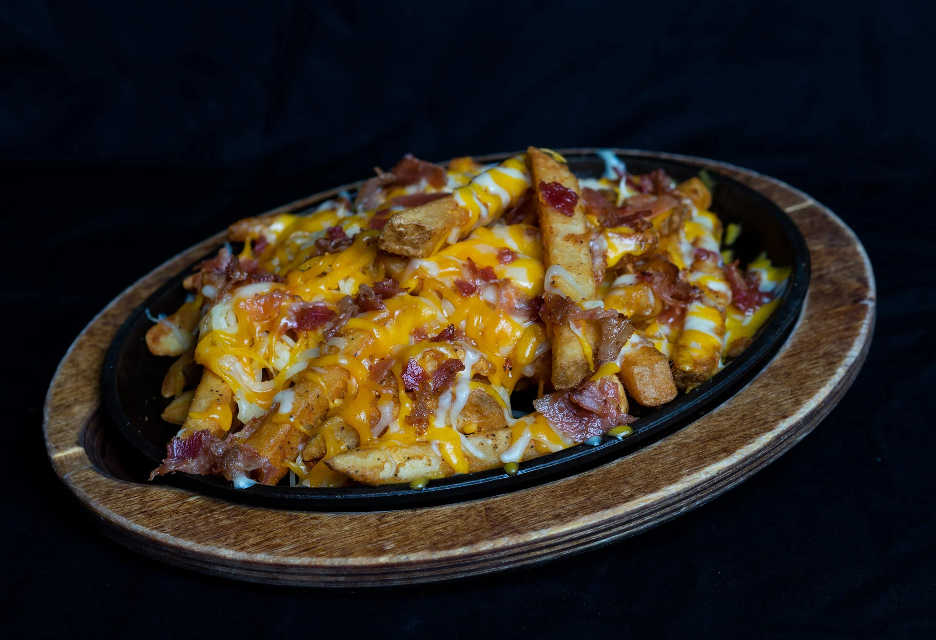 Bacon Cheddar French Fries A heaping order of French fries smothered with melted cheddar-jack cheese and topped with fresh hand cut hickory smoked bacon. 6.00