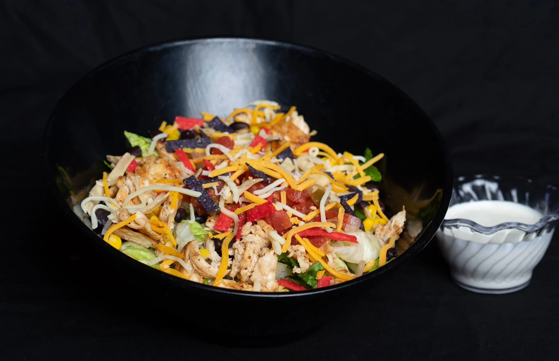 Southwest Chicken Salad Fresh mixed greens topped with fajita grilled chicken breast, black bean corn relish, Pico de Gallo, cheddar jack cheese, and tortilla strips. Served with a side of jalapeno ranch dressing. 12.00