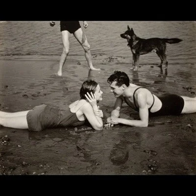 Is there anything better than a carefree summer day at the beach?

This untitled photo, taken nearly a century ago by Edward Steichen, still captures a joy that feels timeless. A young couple lounges in the sand, smiling at one another with effortles