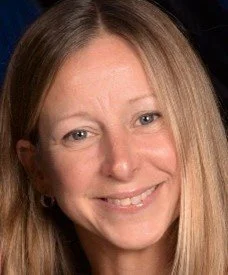 Close-up photo of a woman with long blonde hair smiling at the camera.